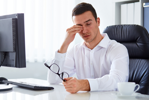 tired man sitting at a desk