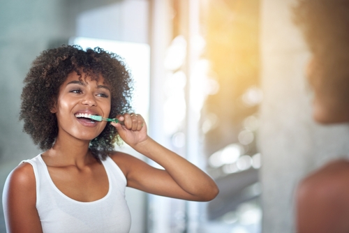 woman brushing her teeth 