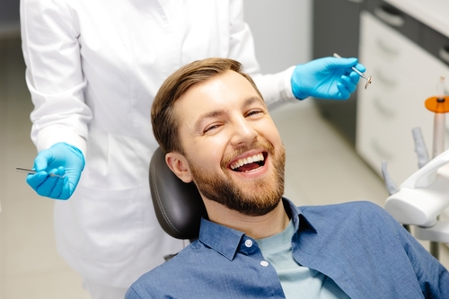 happy man sitting in dentist chair
